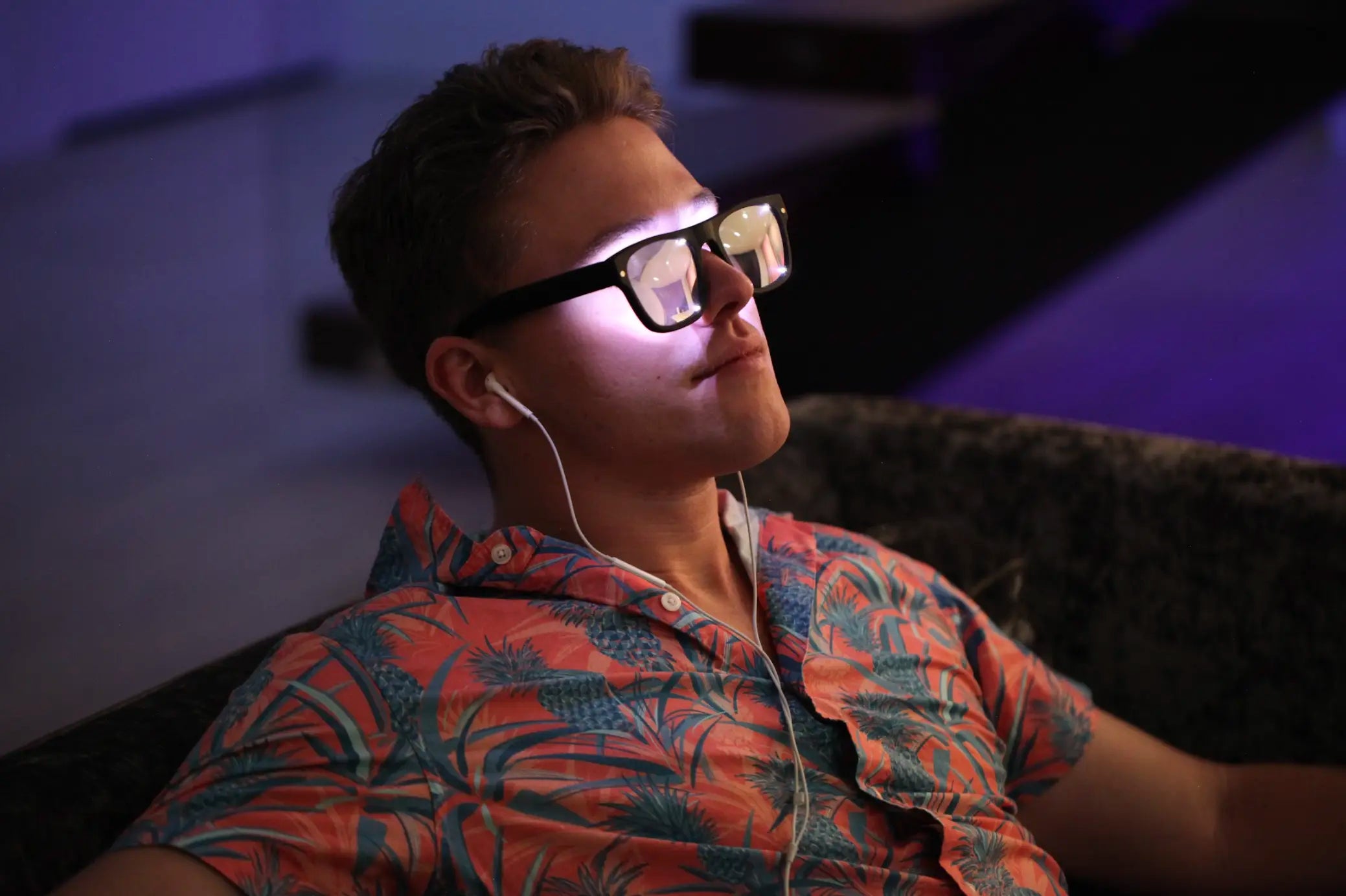 Man listening to music and wearing Healyan Glasses.